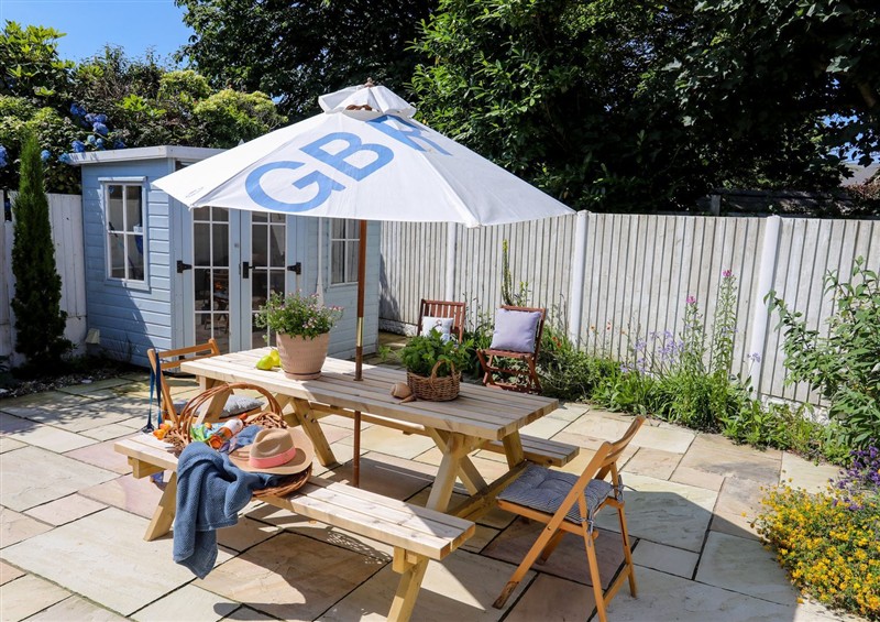 Enjoy a glass of wine on the patio at 15 Llwyn Gwalch Estate, Morfa Nefyn
