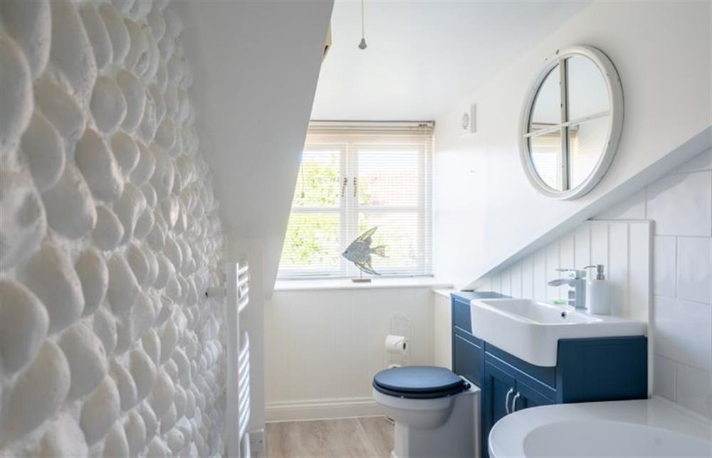 Bathroom with bath with shower over, wash basin and WC at 154 Blakeney High Street, Blakeney near Holt