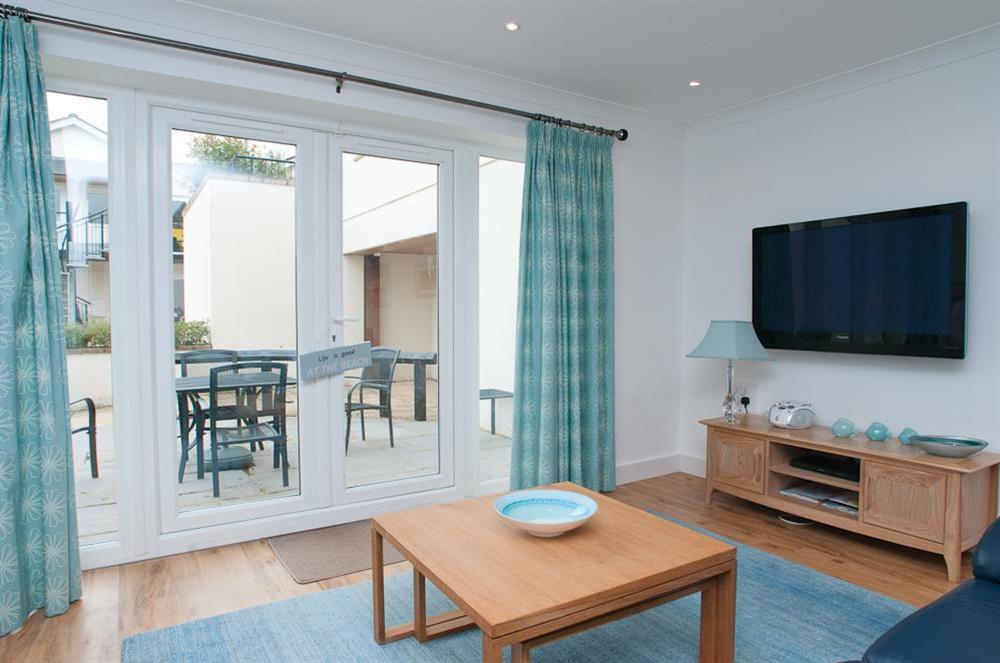 Sitting room has two leather sofas and doors out to terrace (photo 2) at 16 Bolt Head in South Sands, Salcombe