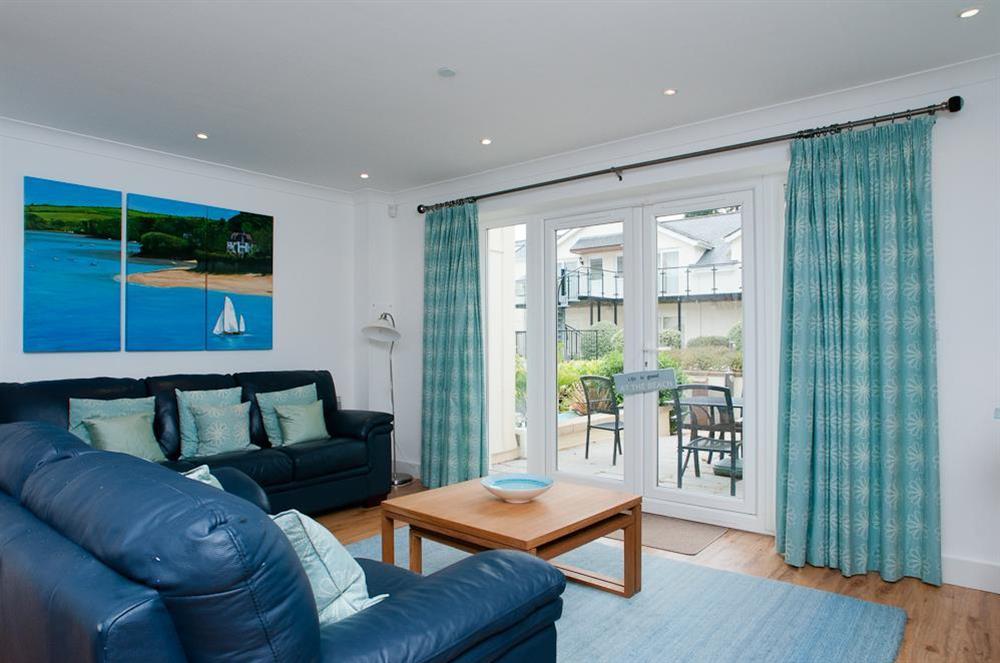 Sitting room has two leather sofas and doors out to terrace at 16 Bolt Head in South Sands, Salcombe