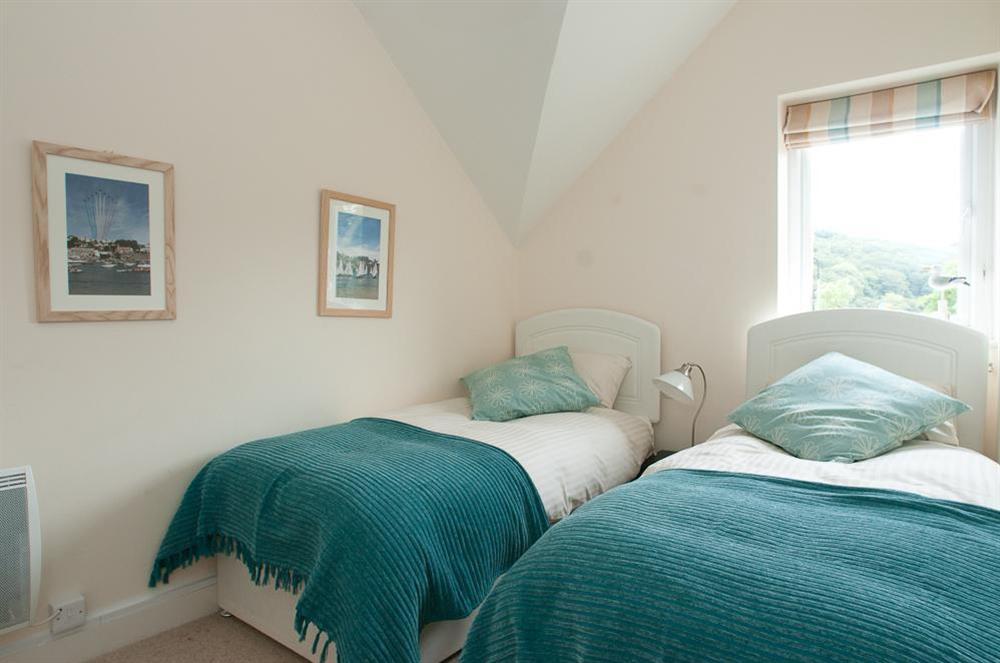 Twin bedroom with view over South Sands beach from the window at 16 Bolt Head in South Sands, Salcombe