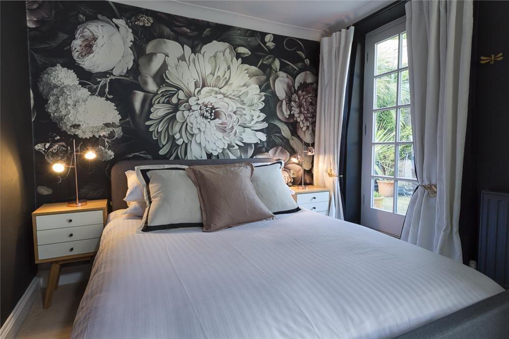 Master bedroom with King-size bed, en suite bathroom and door out to the decked terrace at 16 Courtenay Street in , Salcombe