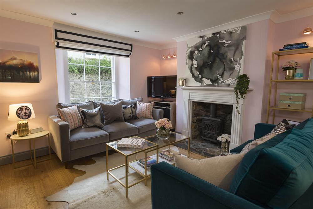 Open-plan living area with feature fireplace at 16 Courtenay Street in , Salcombe