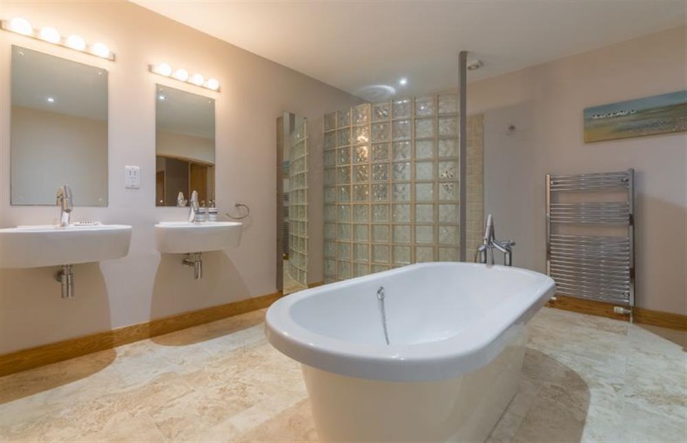 Ground floor:  En-suite bathroom with feature mirrors and two washbasins at 16 The Granary, Wells-next-the-Sea