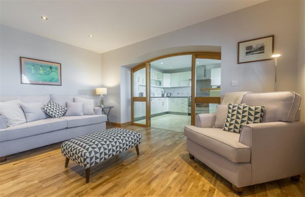 Ground floor:  Sitting room with comfy sofas and double doors to dining/kitchen at 16 The Granary, Wells-next-the-Sea