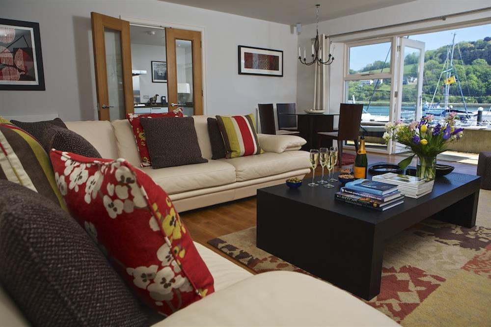 Large, sunny lounge with dining table and doors leading to the terrace at 18 Dart Marina in , Dart Marina