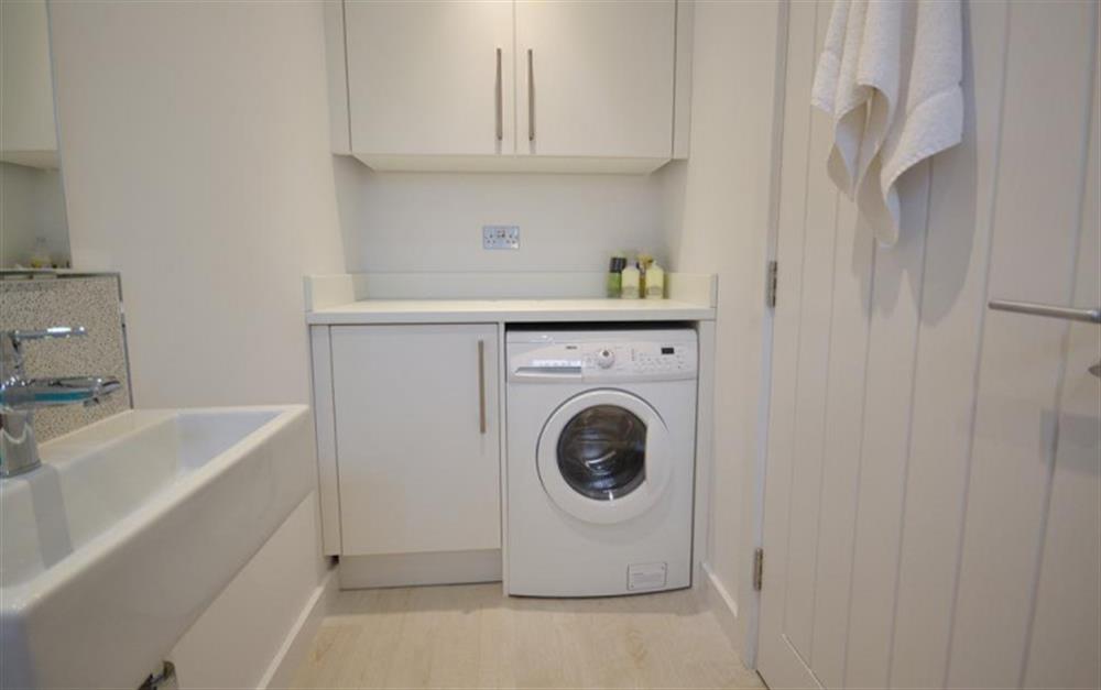 The cloakroom has the washing machine housed within at 18 Talland in Talland Bay