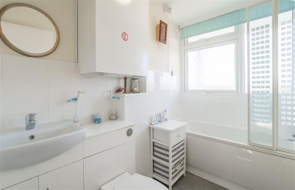Bathroom with bath with shower over, wash basin and WC. at 18 Undercliffe, Felixstowe