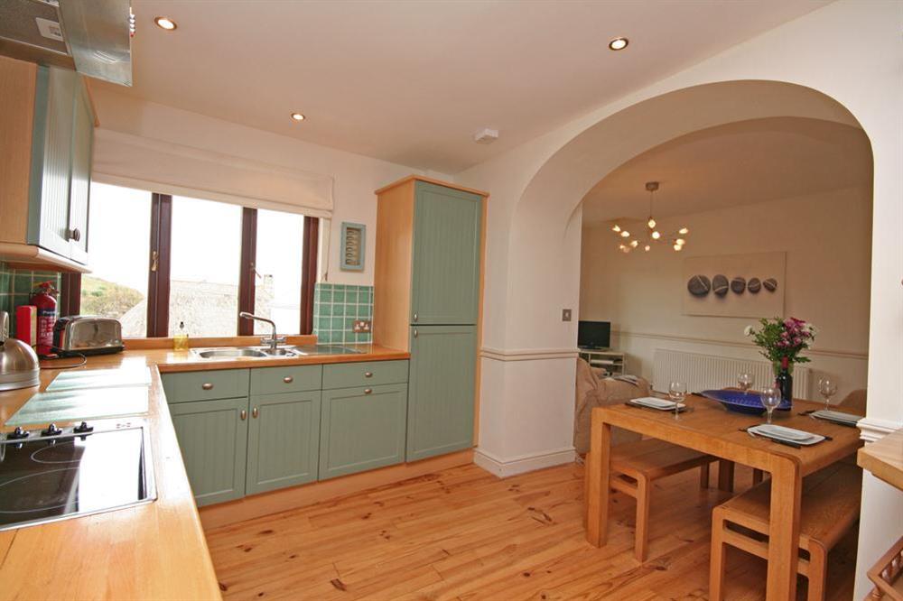 Fully fitted modern kitchen leading to the dining area at 2 Armada Apartments in Hope Cove, Nr Kingsbridge