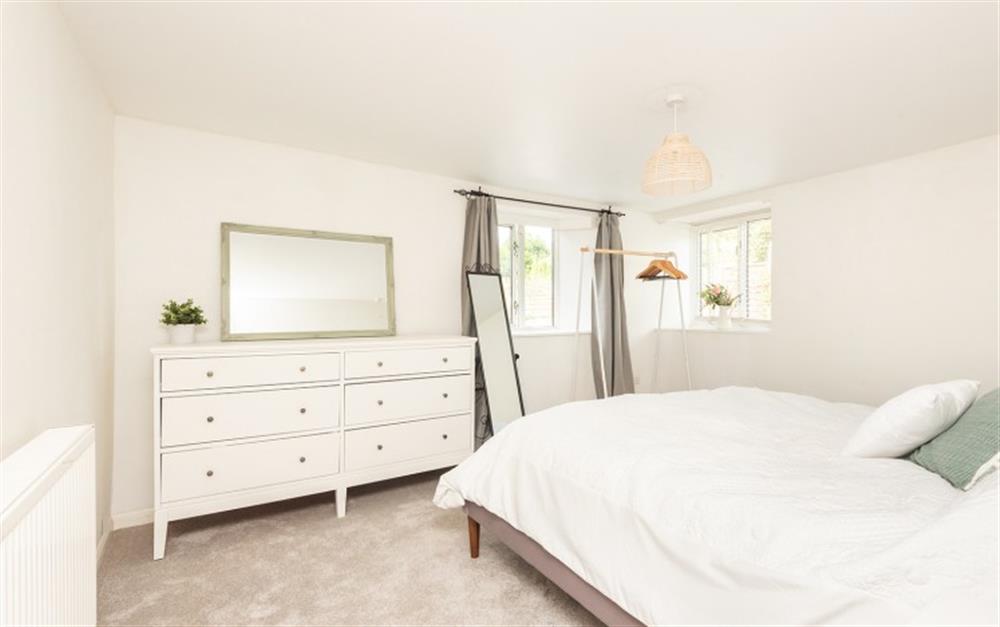 The master bedroom with garden views with a super king bed at 2 Bank Cottage in Chillington