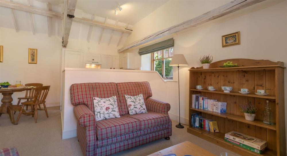 The cosy sitting dining room at 2 Cart Lodge Barn in Upper Sheringham, Norfolk