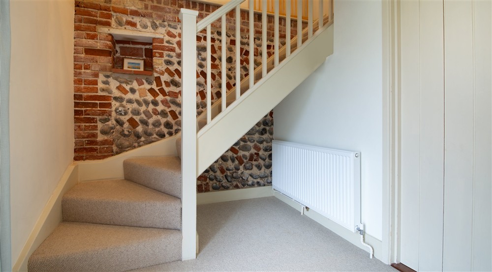 The entrance and stairs at 2 Cart Lodge Barn in Upper Sheringham, Norfolk