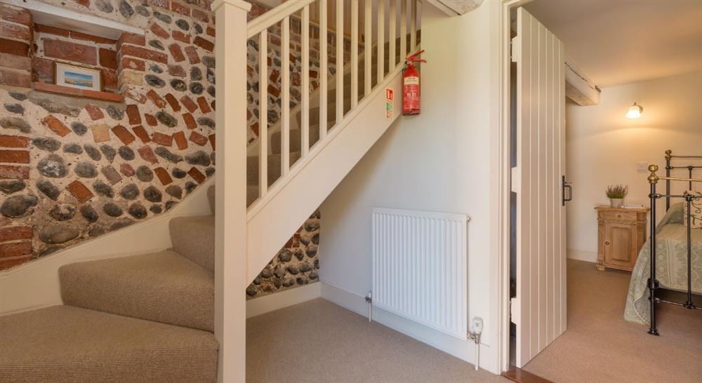 The stairs from ground floor hallway to first floor at 2 Cart Lodge Barn in Upper Sheringham, Norfolk