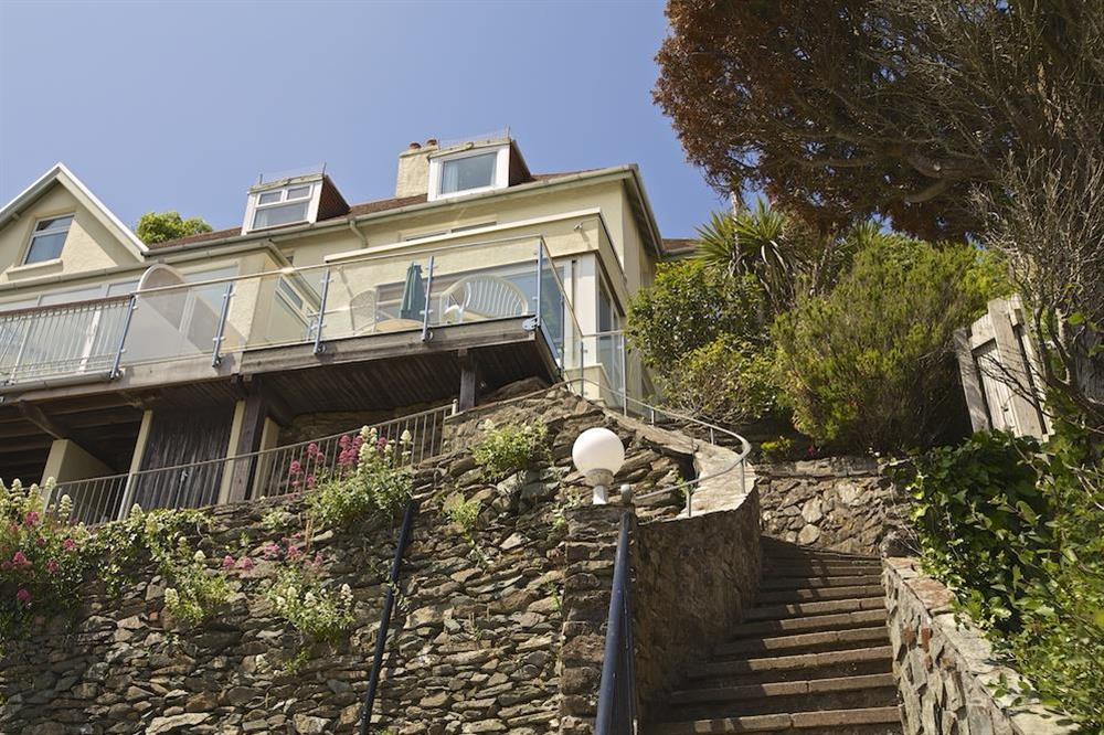 Steps lead up to the property from the parking area at 2 Channel View in Bennett Road, Salcombe