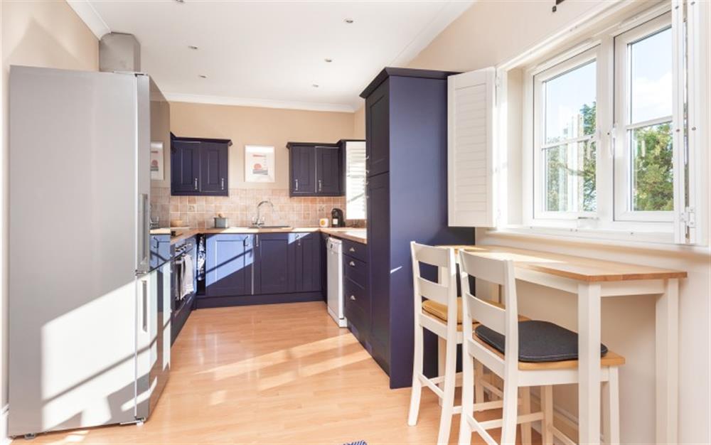 Spacious open-plan kitchen with breakfast bar overlooking far reaching countryside views. at 2 Chapel Street in Blackawton