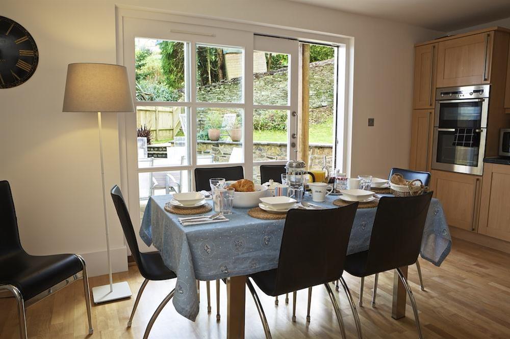 Large open plan ground floor kitchen/dining area with doors leading out to the garden. (photo 2) at 2 Combehaven in Allenhayes Road, Salcombe