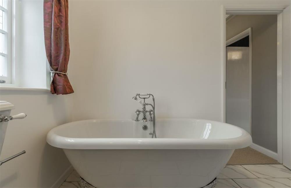 First floor: Family bathroom with roll top bath tub at 2 Dix Cottages, Thornham near Hunstanton