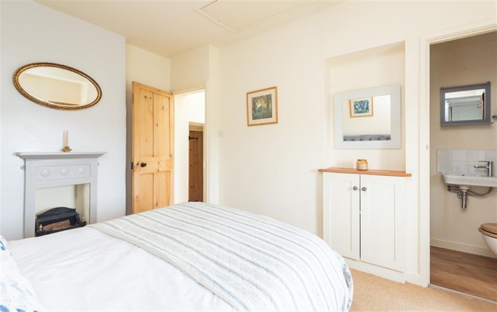 Another view of the master bedroom peeking into the en suite at 2 Florence Cottage in Torcross