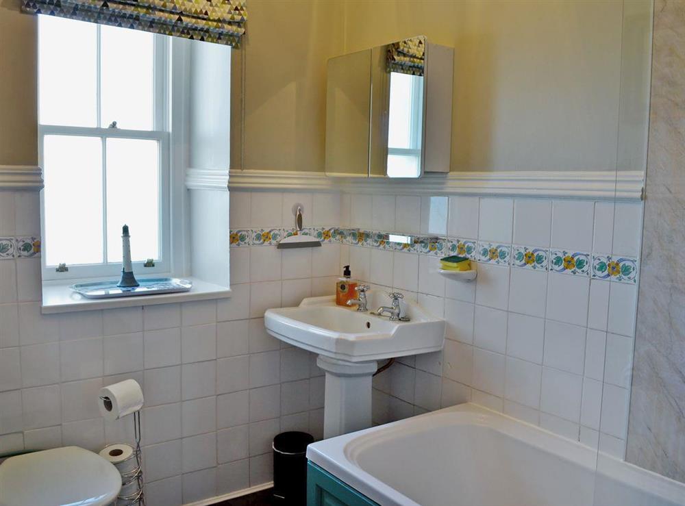 Bathroom with shower over bath and WC at 2 Girdleness Lighthouse in Aberdeen, Aberdeenshire