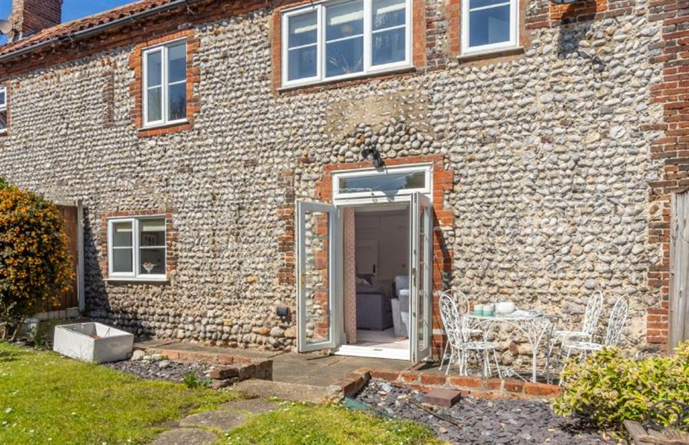 French doors from the sitting area open to the rear garden at 2 Hammond Square, Weybourne near Holt