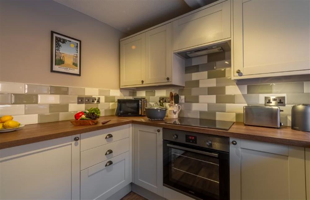 Ground floor: A smart, fully tiled kitchen at 2 Hammond Square, Weybourne near Holt