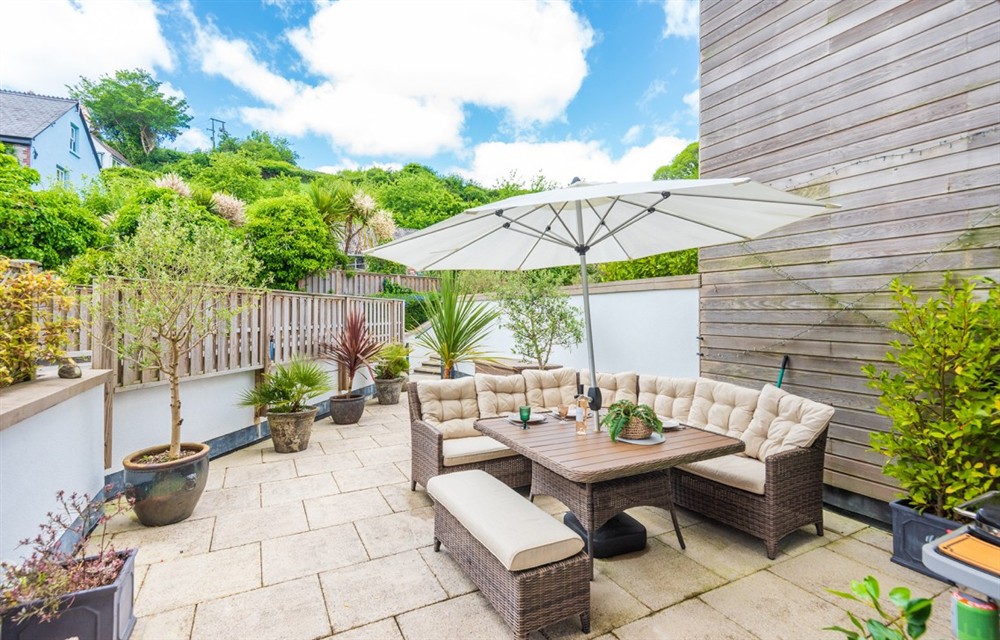 Enjoy a glass of wine on the patio at 2 Island Place (Harbour Lights) in Salcombe