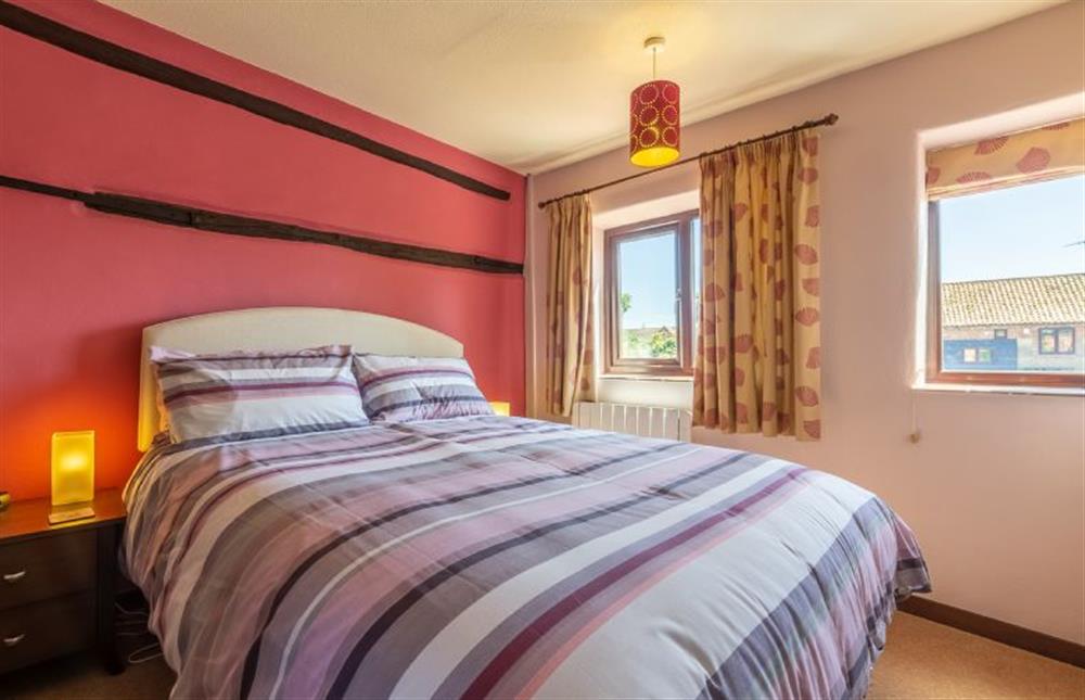 First floor: Master bedroom with king-size bed at 2 Manor Court, Syderstone near Kings Lynn