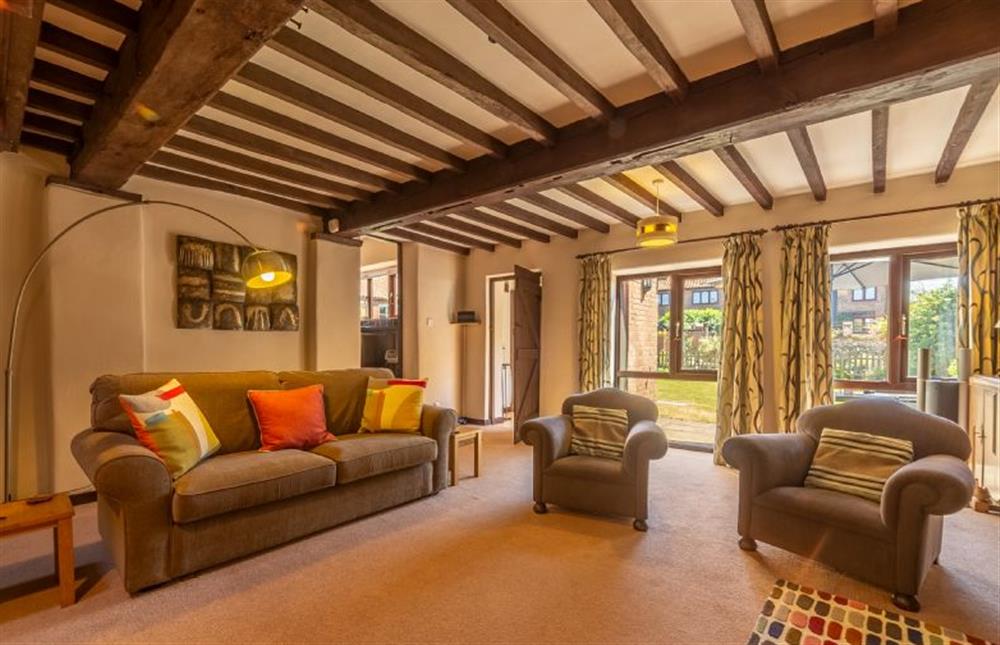 Ground floor: Sitting area with wood burning stove at 2 Manor Court, Syderstone near Kings Lynn