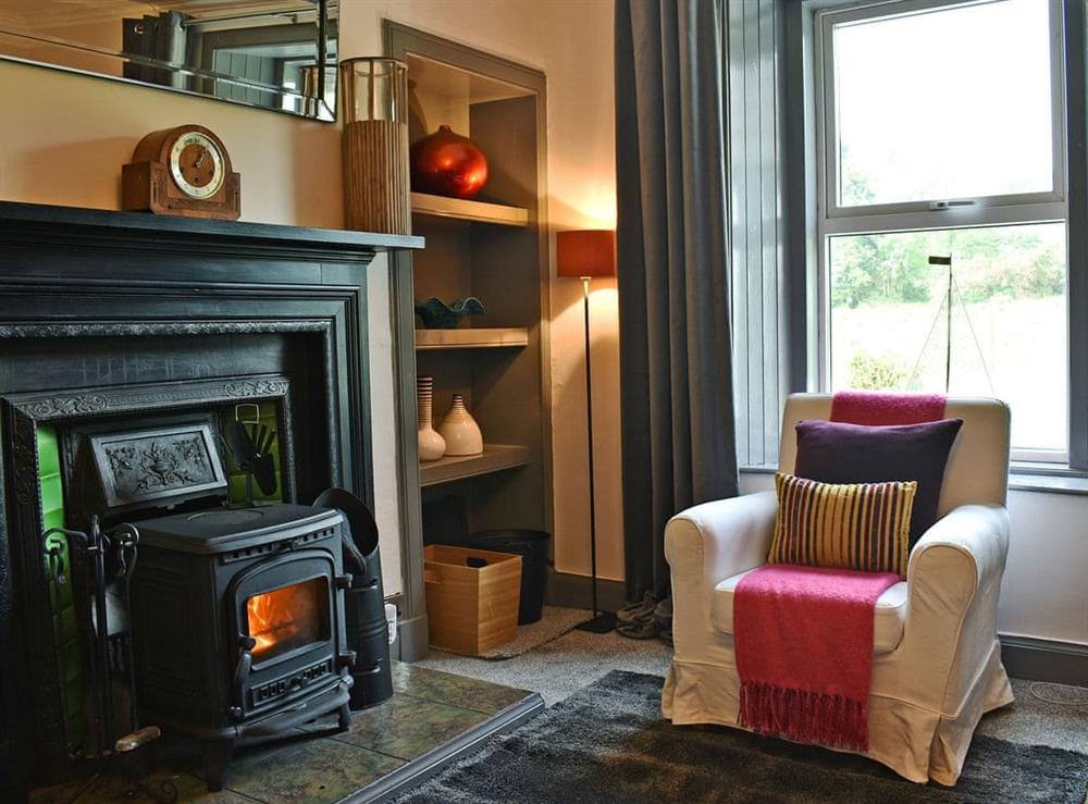 Stylishly furnished living room with wood burner (photo 2) at 2 Northbank Cottages in Whiting Bay, Isle of Arran, Scotland