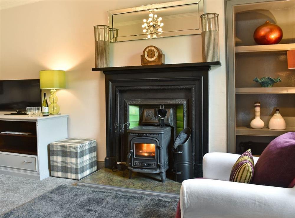 Stylishly furnished living room with wood burner at 2 Northbank Cottages in Whiting Bay, Isle of Arran, Scotland
