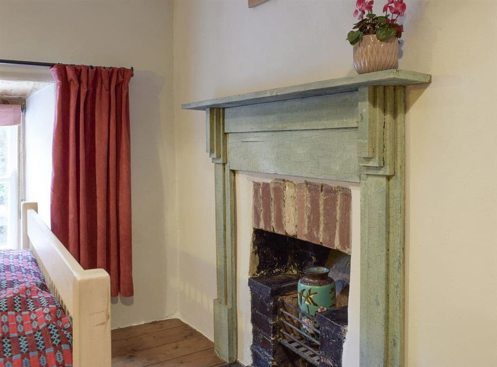 Characterful fireplace within double bedroom at 2 Penrhiw in Abercych, near Newcastle Emlyn, Dyfed