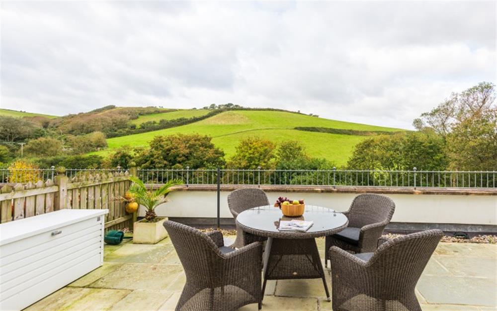 The large rear terrace with views over the countryisde beyond and the swimming pool at 2 Prospect House in Hallsands