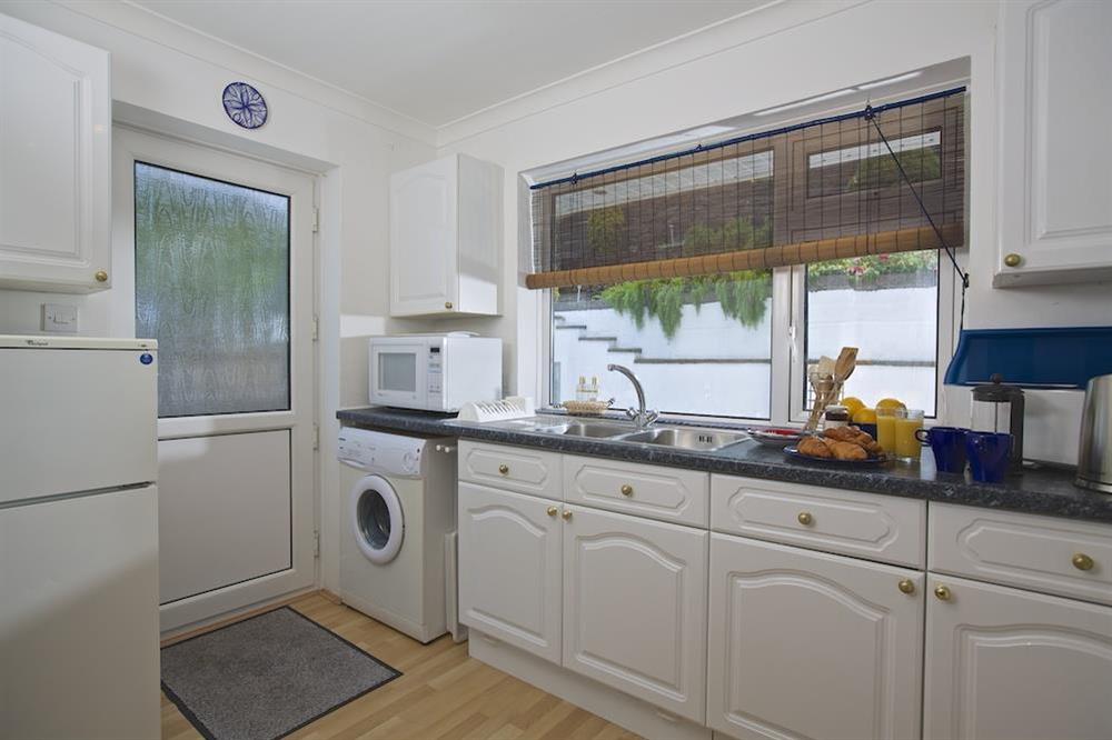Kitchen with door leading to the terrace at 2 Rockmount in Knowle Road, Salcombe