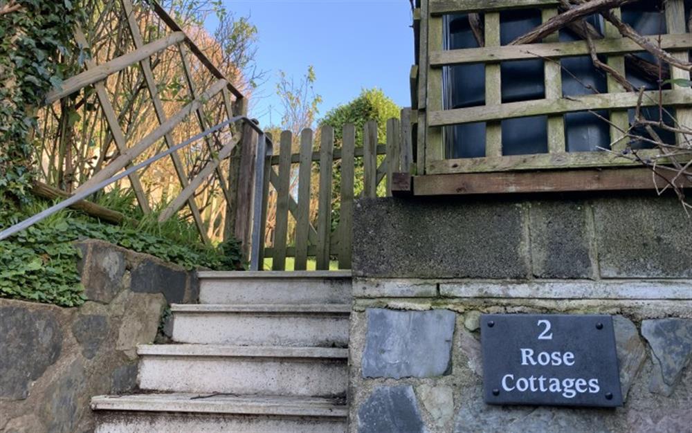 Steps up from the private parking space at 2 Rose Cottages in Sherford