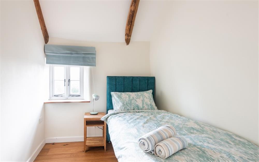 The single bedroom with views over the garden at 2 Rose Cottages in Sherford