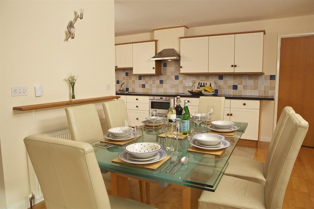 Dining area with glass-topped table and seating for six at 2 Sea Gardens in Hope Cove, Nr Kingsbridge