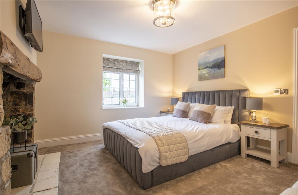 Bedroom one with a 5’ king-size bed at 2 West End,  Northallerton
