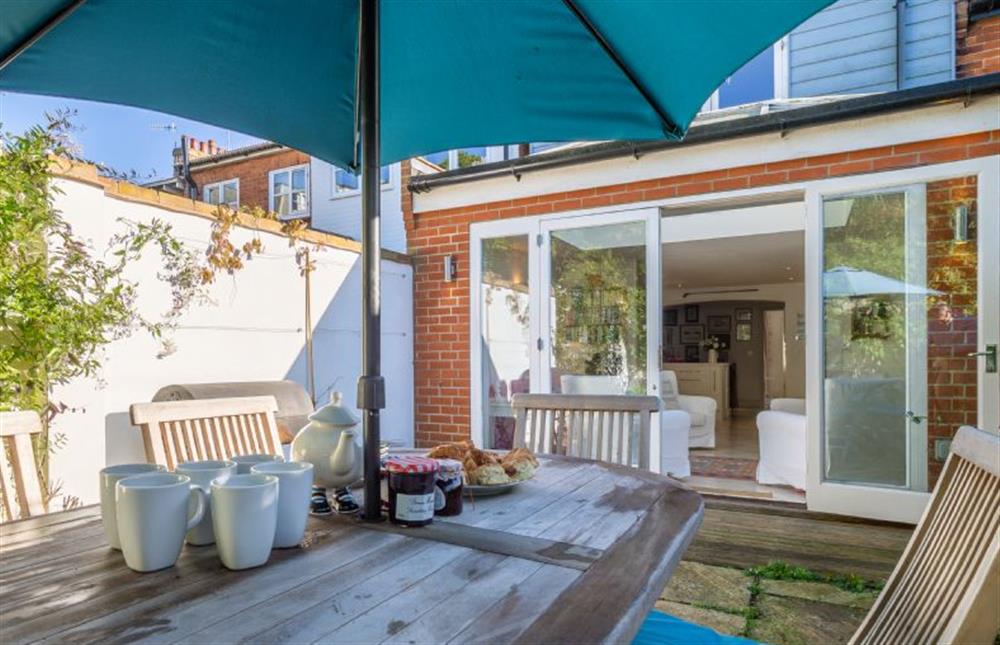 Enclosed courtyard garden with garden furniture and a charcoal barbecue at 207 High Street, Aldeburgh