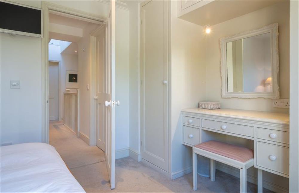 Master bedroom with lots of storage space and dressing table at 207 High Street, Aldeburgh