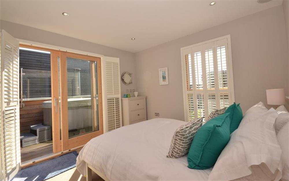 The master double bedroom showing the hot tub on the balcony at 21 Talland in Talland Bay