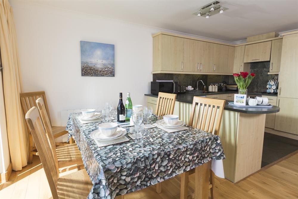 Open plan living area with dining table seating four at 25 Burgh Island Causeway in , Bigbury-on-Sea