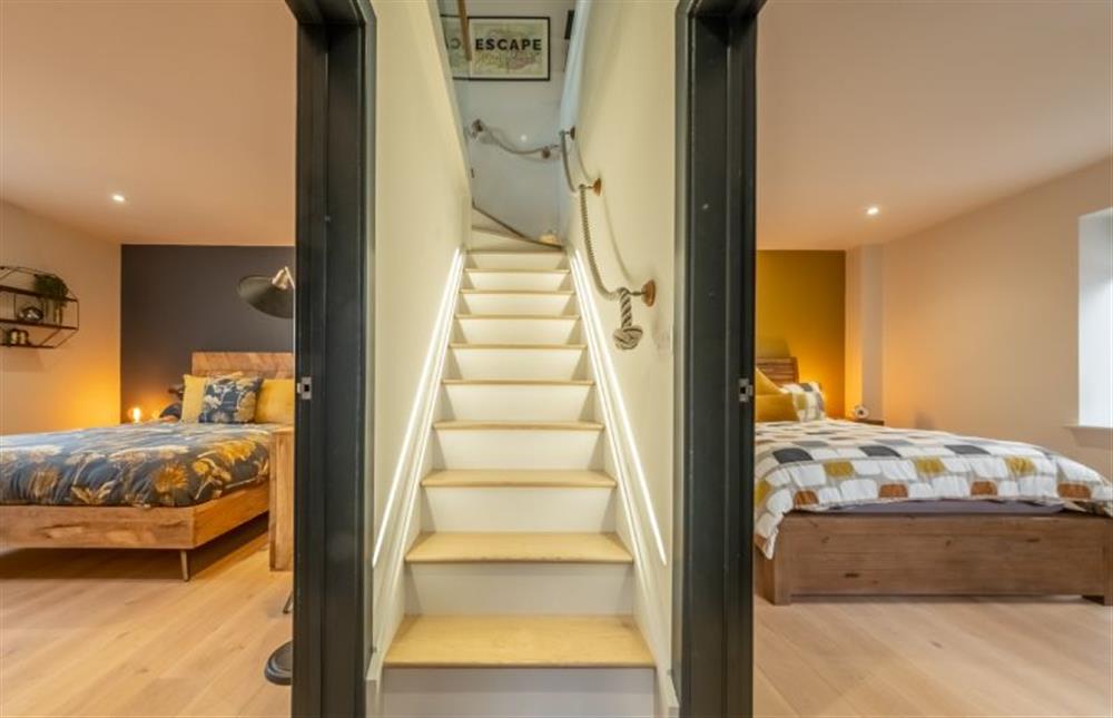 The stairway divides the bedroom at 28 Chapel Yard, Wells-next-the-Sea