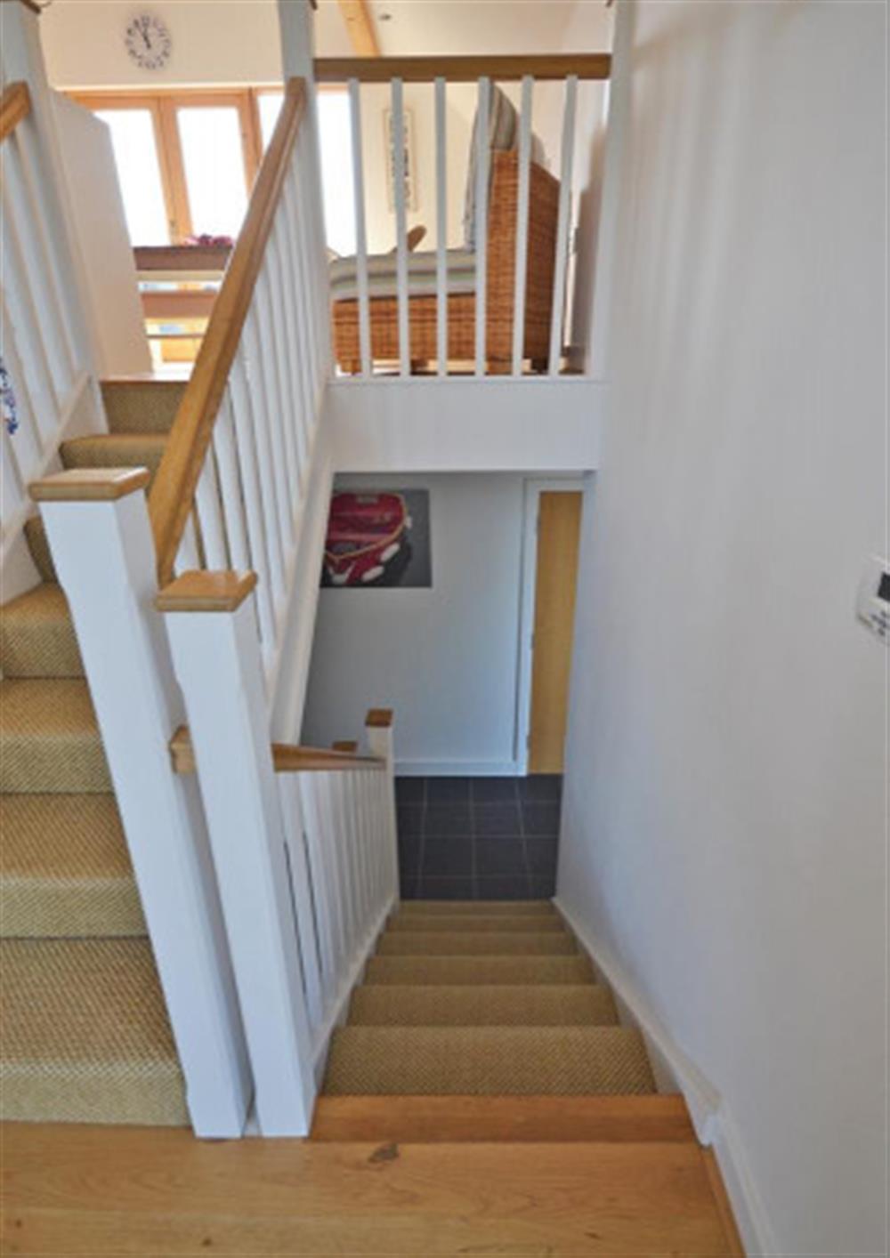 Stair well down to bedrooms at 28 Talland Bay in Looe