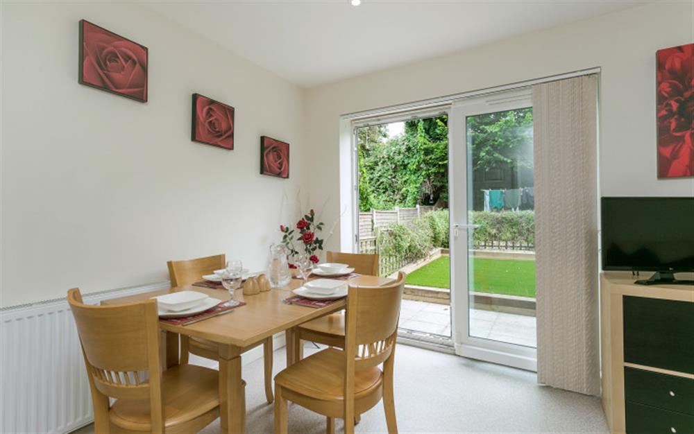 Dining area with doors to the patio at 3 Allington Square in Bridport