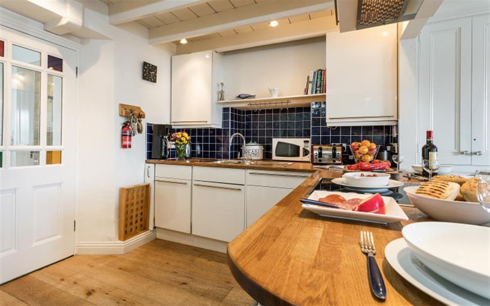 The modern kitchen is fully fitted and well equipped. at 3 Coastguard Cottage, River View in Helford Passage