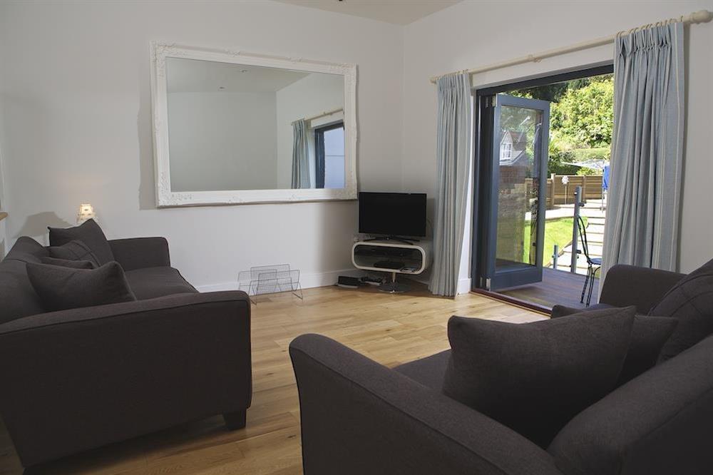 The living area has double doors out to the decking at 3 Eddystone Row in , Salcombe