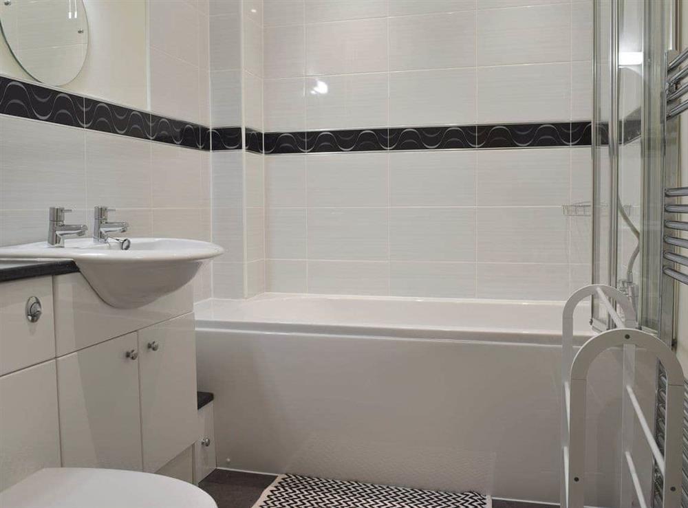 Bathroom with shower over bath at 3 Greta Grove House in Keswick, Cumbria