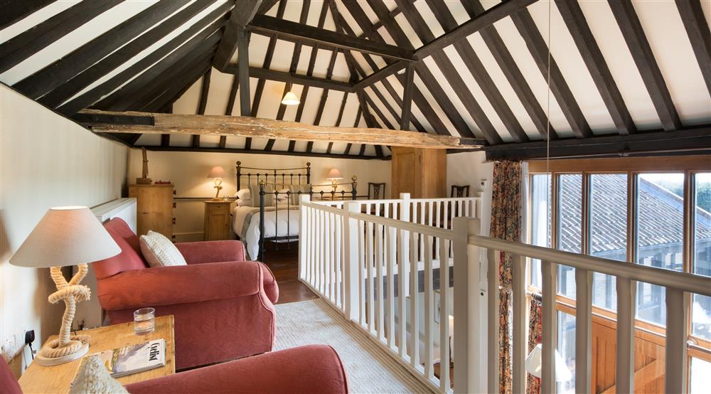 The galleried sitting area and bedroom at 3 Horsey Barns in Horsey, Norfolk