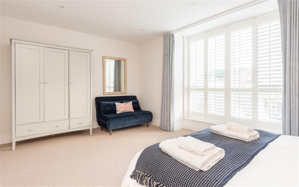 Bedroom 1 with 5ft King size bed, sofa and wardrobe at 3 Island Place (Saltstone) in Salcombe