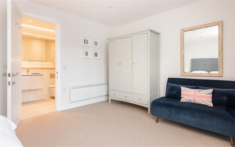 Bedroom 1 with sofa and wardrobe at 3 Island Place (Saltstone) in Salcombe